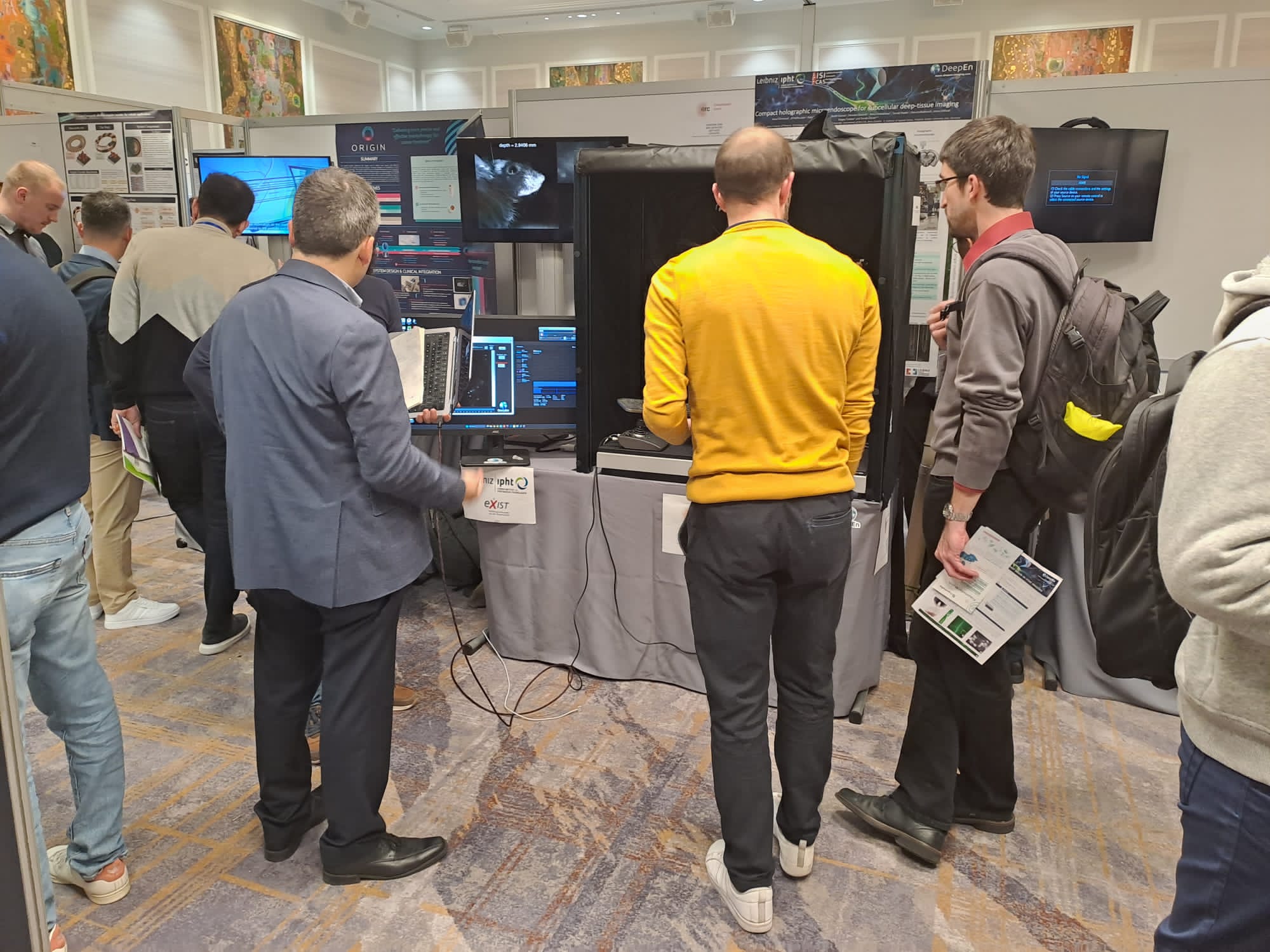 Attendees watching the DeepEn One holographic endoscope demonstration at the IEEE Sensors 2023 conference in Vienna.