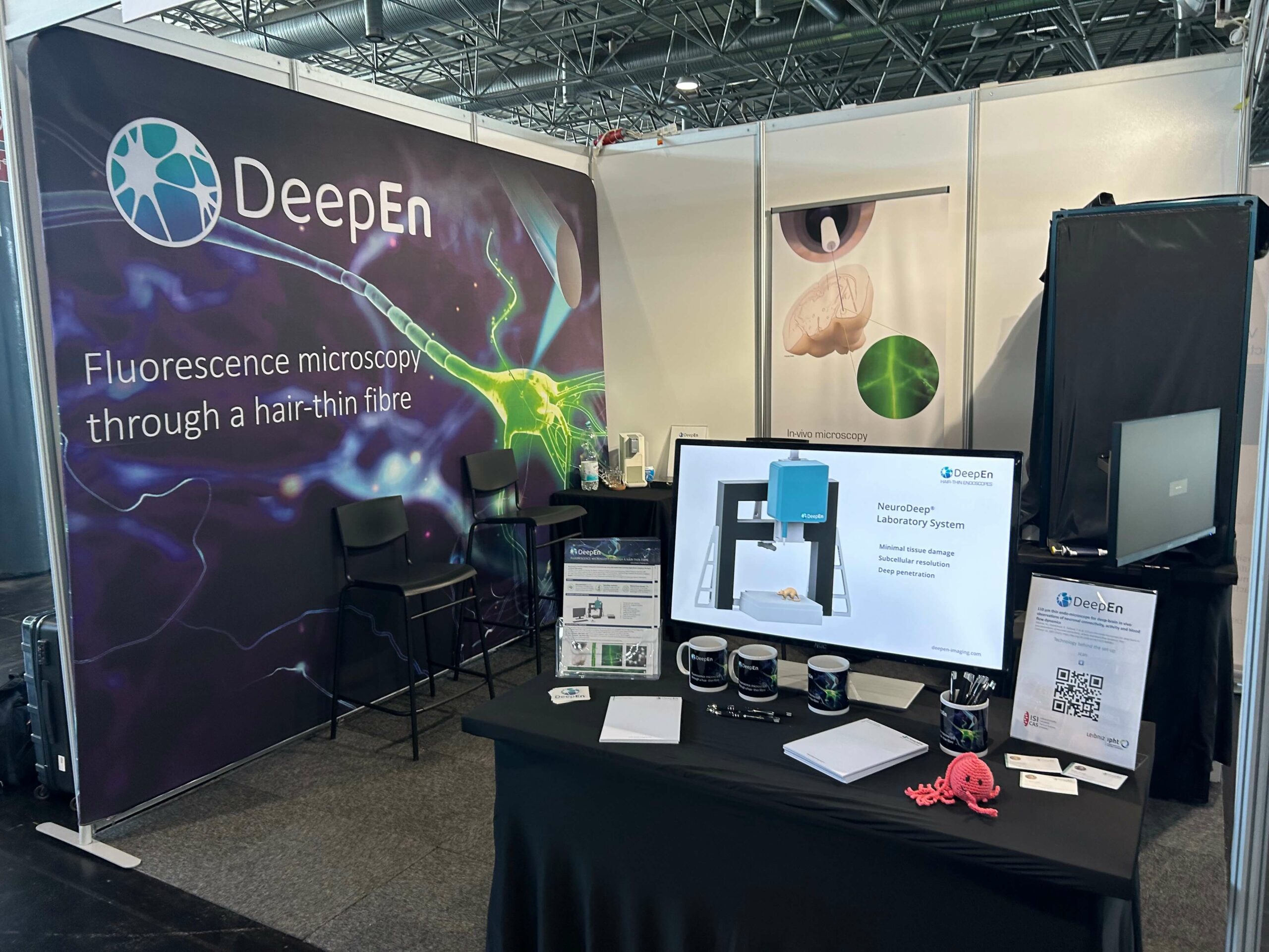 DeepEn booth at the FENS 2024 neuroscience conference in Vienna, displaying the DeepEn One holographic endoscope system.