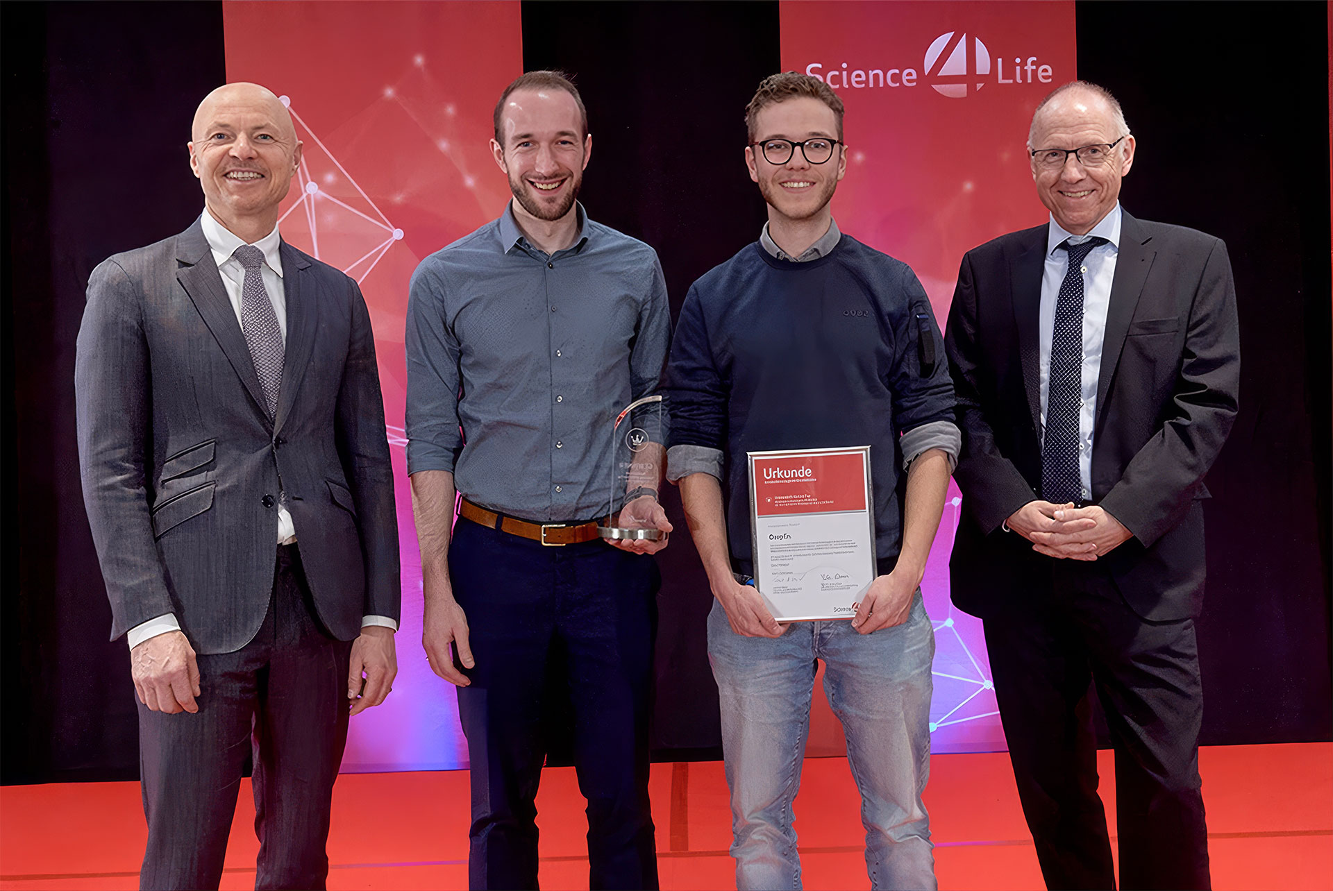 DeepEn representatives on stage receiving the Science4Life Venture Cup award during the second phase of the competition.